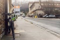 Bicycle parked on sidewalk near city street in Spain. Bike lean on pole beside old building. Front view of bicycle on blurred Royalty Free Stock Photo