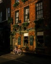 Bicycle parked in an urban alleyway, beside an building Royalty Free Stock Photo