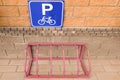 Bicycle parking and road sign. View from the front. In the city near the house. Metallic design Royalty Free Stock Photo