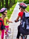 Bicycle path with children. Girls wearing helmet with rucksack . Royalty Free Stock Photo