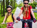 Bicycle path with children. Girls wearing helmet with rucksack . Royalty Free Stock Photo