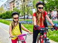 Bicycle path with children. Girls wearing helmet with rucksack . Royalty Free Stock Photo