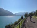 Bicycle path bike man cycling lake water panorama mountains