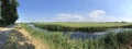 Bicycle path next to a canal and farming landscape