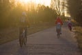 Bicycle path, people ride their whole family on bicycles, a sporty and healthy lifestyle and the setting sun Royalty Free Stock Photo