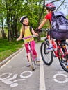 Bicycle path sign with children. Girls wearing helmet with rucksack . Royalty Free Stock Photo