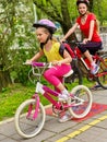 Bicycle path sign with children. Girls wearing helmet with rucksack . Royalty Free Stock Photo