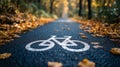 Bicycle path lined with autumn leaves in a serene forest setting during daylight hours Royalty Free Stock Photo