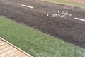 Bicycle path with a symbol of a bicycle, next to a pedestrian area made of wood. Sports and recreation, active lifestyle