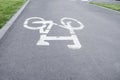 Bicycle path. Bicycle symbol on street. White bicycle sign on asphalt bike lane