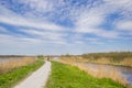 Bicycle path at the water in the nature reserve of Alde Feanen in Friesland Royalty Free Stock Photo