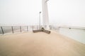 Bicycle pedestrian bridge with fog and an bench