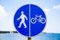 Bicycle and pedestrian lane sign against the sea