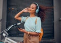 Bicycle, phone and black woman on headphones in city streaming audio, music or podcast. Happy, travel and female from Royalty Free Stock Photo