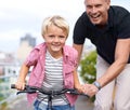 Bicycle, portrait and father with boy child in a road for help, learning or outdoor ride together. Love, family or Royalty Free Stock Photo