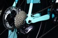 bicycle rear wheel with gearshift chainrings and steel spokes. white metal frame. macro view.