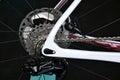 bicycle rear wheel with gearshift chainrings and steel spokes. white metal frame. macro view. Royalty Free Stock Photo