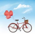 Bicycle with red heart shaped balloons in front of a blue sky background. Royalty Free Stock Photo