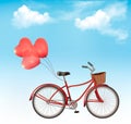 Bicycle with red heart shaped balloons in front of a blue sky Royalty Free Stock Photo