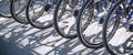 Bicycle rent Public bicycles, sharing  bikes saddle. Detail view of a bike wheel with more bicycles lined up. Bicycle rent. Closeu Royalty Free Stock Photo