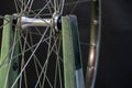 Bicycle repair. The front wheel is on a stand on a black background. Rim and spokes close-up. Mechanic levels the wheel in the Royalty Free Stock Photo