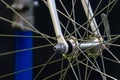 Bicycle repair. The front wheel is on a stand on a black background. Rim and spokes close-up. Mechanic levels the wheel in the Royalty Free Stock Photo