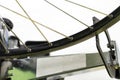 Bicycle repair. The front wheel is on a stand on a white background. Rim and spokes close-up. Mechanic levels the wheel in the Royalty Free Stock Photo