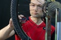 Bicycle repair. Rear wheel and tire closeup. Mechanic repairing spokes of the rear wheel of a mountain bike. Bike mechanic in the