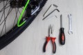 Bicycle and repair tools screwdriver wrench hex wrenches pliers cable cutter on wooden background