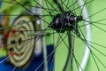 Bicycle repair workshop. On the hook hang new wheels. The rim, spokes and hub black colour. The old bike here is gets a second