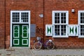 Bicycle rests against a brick wall