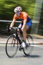Bicycle rider with orange shirt in motion