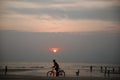 Bicycle rider at sunset on the beach, coast of ocean or sea. Idyllic picture Royalty Free Stock Photo