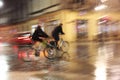 Bicycle riders at rainy night