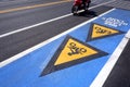 Bicycle road sign, arrow with bike lane text and blurred motion of motorcycle on asphalt road Royalty Free Stock Photo