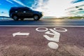 Bicycle road sign with motion blur of car
