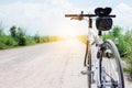 bicycle on rural road with grass at sunset