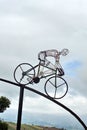 Bicycle sculpture in silhouette on the side of the road