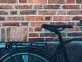 Bicycle seat leaning on to brick wall in Halmstad, Sweden Royalty Free Stock Photo