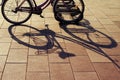 Bicycle shadow parked at sunset in the evening Royalty Free Stock Photo