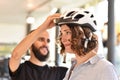 Bicycle shop consulting - customer tests a bicycle helmet for road safety