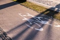 Bicycle sign in modern city, bike sign on a street. Painted Street Asphalt Bicycle Lane Sign White Safety. Royalty Free Stock Photo