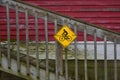 Bicycle Sign on a Staircase of Red Building