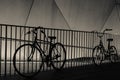 Bicycle Silhouettes against Railing at Night Royalty Free Stock Photo