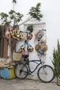 Bicycle standing in front of merchandise in the medina of Asilah