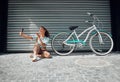 Bicycle, street and woman taking a selfie in a city blowing a kiss in photo or pictures in summer outdoors. Freedom Royalty Free Stock Photo