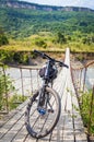 Bicycle on suspension cable bridge, Crossing the river. Adygea republic, Krasnodar region, Russia Royalty Free Stock Photo