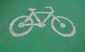 Bicycle symbol on green asphalt road, Surface rough of bike lane, Texture Background. Royalty Free Stock Photo