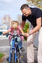 Bicycle, teaching and father with boy child in a road for help, learning or outdoor ride together. Love, family or Royalty Free Stock Photo