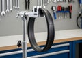 Bicycle tire mounted on a silver truing stand, positioned in a Royalty Free Stock Photo
